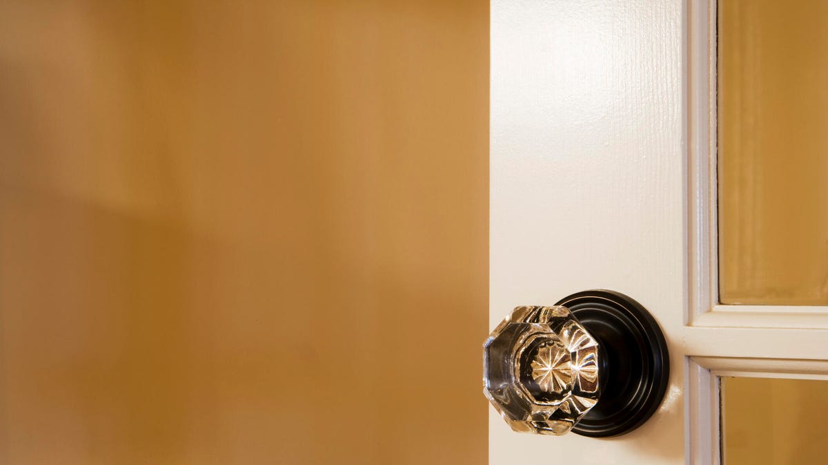 crystal doorknob on a white french door with a yellow background